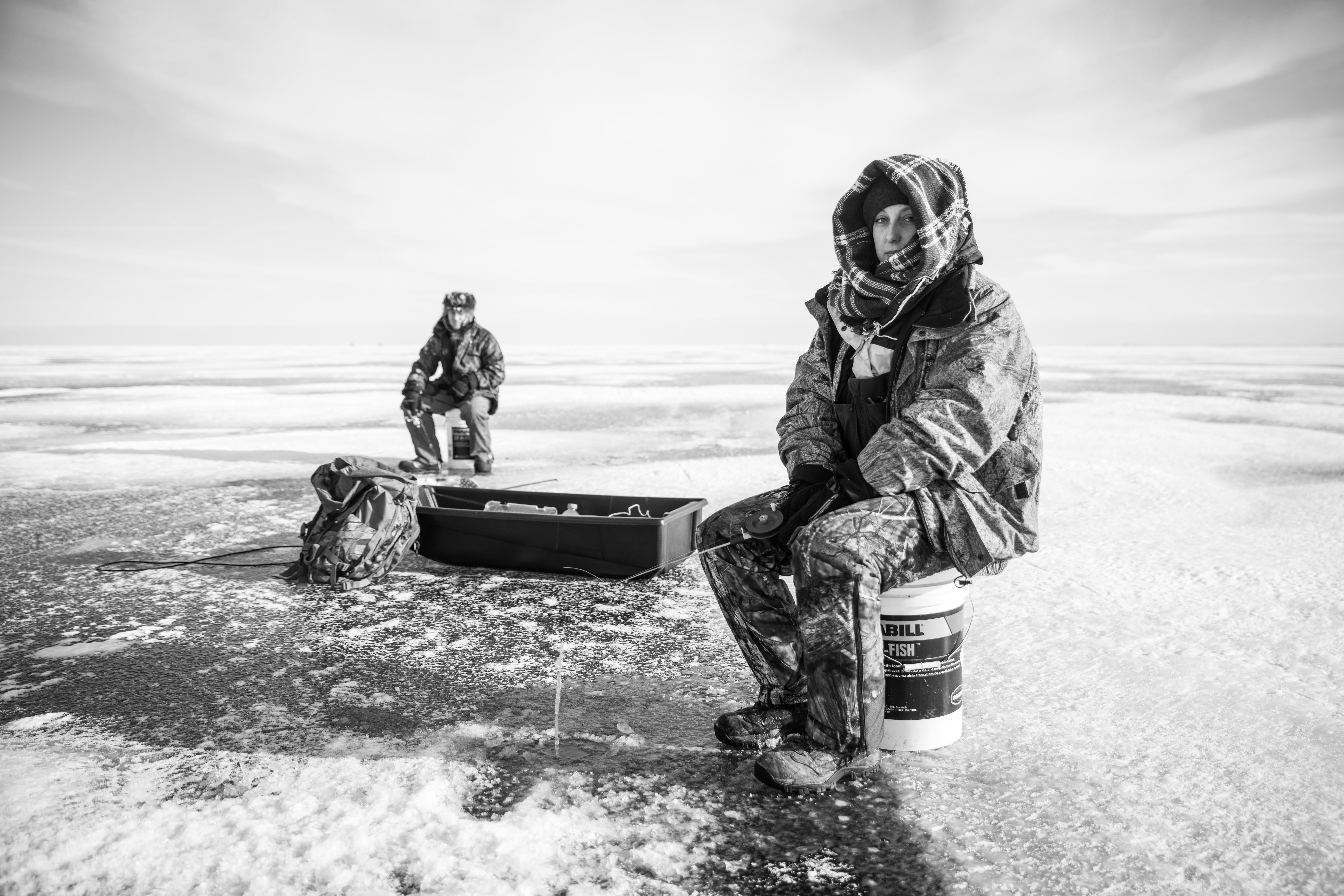 <p><em>April and Edley Lattimore ice fish on Lake Huron. Photo Credit: Amy Saka</em></p>